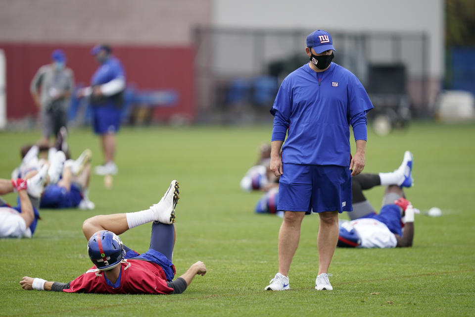 New York Giants head coach Joe Judge talks to his quarterbacks during practice at the NFL football team's training camp in East Rutherford, N.J., Wednesday, Aug. 19, 2020. (AP Photo/Seth Wenig)