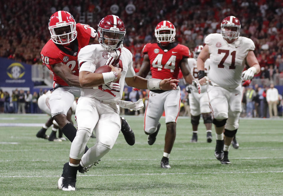 Georgia defensive back J.R. Reed (20) tries to tackle Alabama quarterback Jalen Hurts (2) during the second half of the Southeastern Conference championship NCAA college football game, Saturday, Dec. 1, 2018, in Atlanta. Hurts scored a touchdown on the play. (AP Photo/John Bazemore)