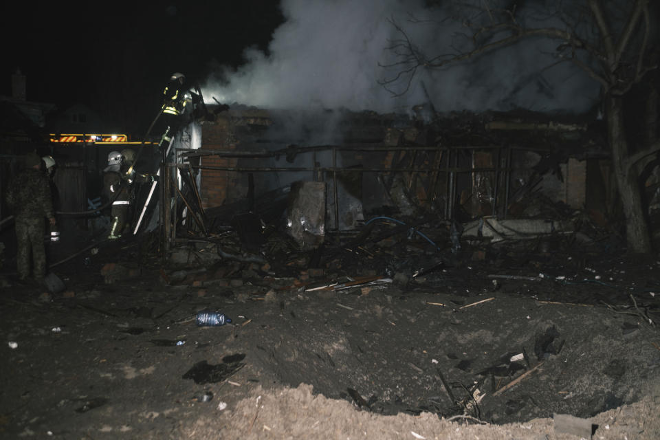 Rescue workers extinguish the fire of a house which was destroyed after a Russian drone strike on residential neighborhood in Kharkiv, Ukraine, on Thursday, April 4, 2024. (AP Photo/George Ivanchenko)