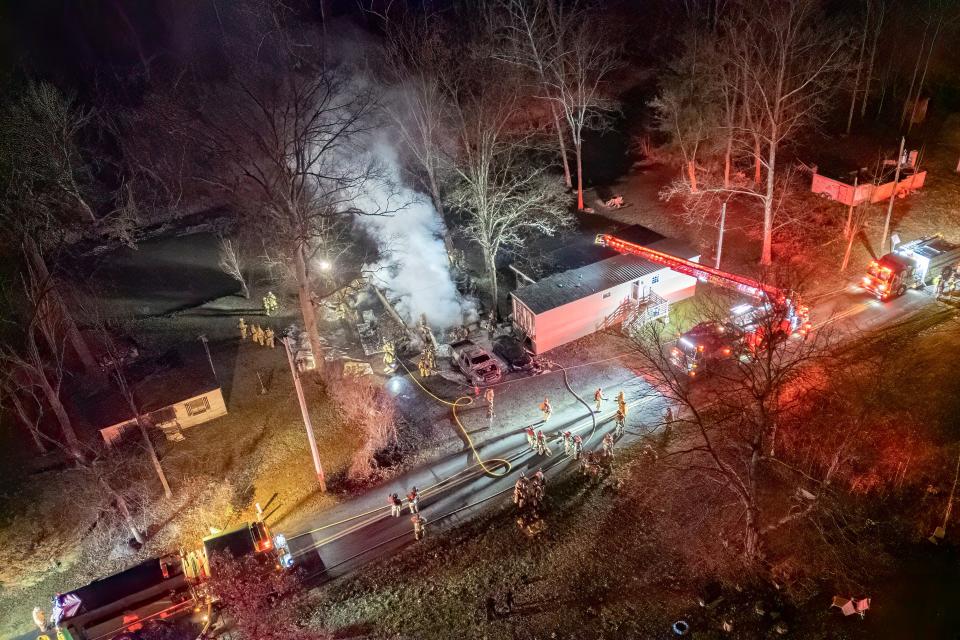 Firefighters battle a garage fire on the 100 block of Fish and Game Road, Friday, Dec. 22, 2023, in Oxford Township.