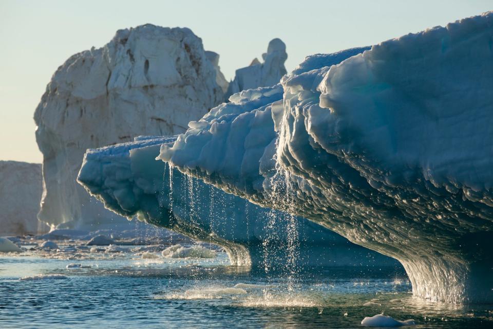 Water is seen streaming off of icebergs.