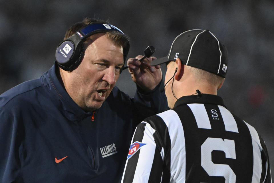 Illinois head coach Bret Bielema talks with an official during the second quarter of an NCAA college football game against Penn State, Saturday, Sept. 28, 2024, in State College, Pa. (AP Photo/Barry Reeger)