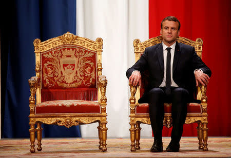 FILE PHOTO: French President Emmanuel Macron listens as Paris Mayor Anne Hidalgo delivers her speech during a ceremony at the Hotel de Ville in Paris, France, May 14, 2017. REUTERS/Charles Platiau/File Photo