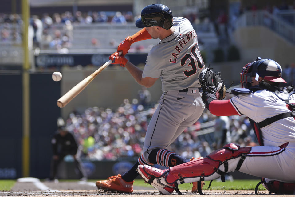 Detroit Tigers' Kerry Carpenter (30) hits an RBI single during the first inning of a baseball game against the Minnesota Twins, Sunday, April 21, 2024, in Minneapolis. (AP Photo/Abbie Parr)