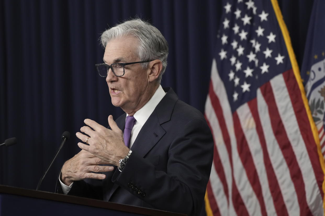 Federal Reserve Chair Jerome Powell speaks at a podium during a news conference. 