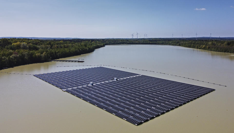 FILE - Solar panels on Germany's biggest floating photovoltaic plant produce energy under a blue sky on a lake in Haltern, Germany, May 3, 2022. The world is falling well short of the progress needed to meet the United Nations’ sustainable development goals by 2030 in areas ranging from poverty to clean energy to biodiversity, according to a report Tuesday, June 20, 2023, from the nonprofit tracking the goals. (AP Photo/Martin Meissner, File)