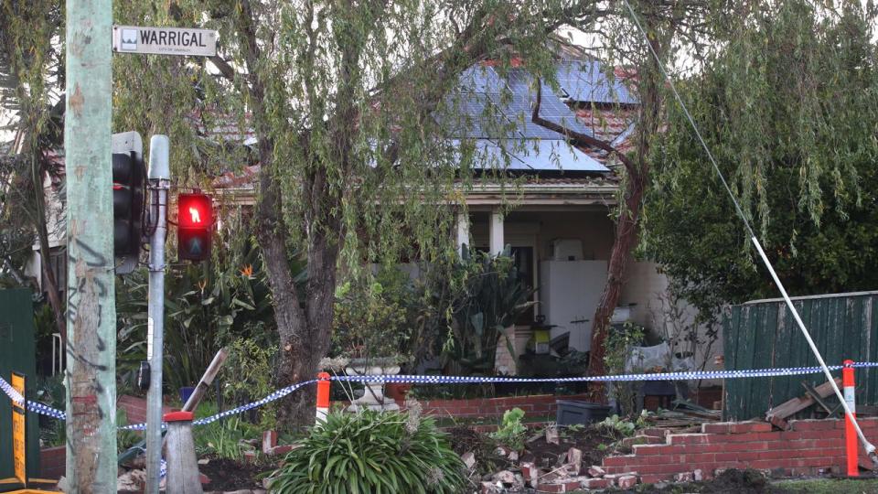 MELBOURNE, AUSTRALIA - NewsWire Photos - 03 JULY, 2024: A driver has been killed in a collision with a stolen car in Burwood. Damage to the front fence of a house that one of the cars crashed through. Wednesday, July 3, 2024. Picture: NewsWire / David Crosling