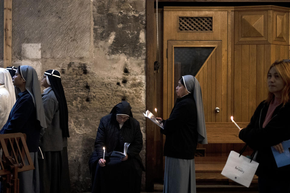 Catholic nuns take part in the Holy Thursday Mass at the Church of the Holy Sepulcher, where many Christians believe Jesus was crucified, buried and rose from the dead, in the Old City of Jerusalem, Thursday, March 28, 2024. (AP Photo/Maya Alleruzzo)