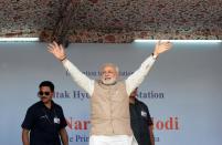 Indian prime minister Narendra Modi waves to supporters during a public rally in Kargil on August 12, 2014