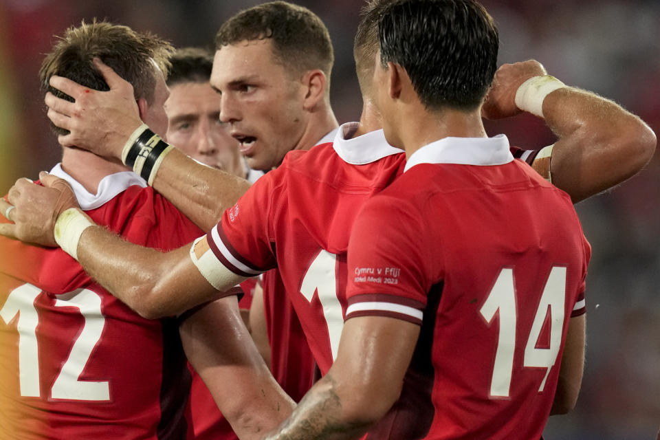 Wales' George North, center, celebrates with teammates after marking a try during the Rugby World Cup Pool C match between Wales and Fiji at the Stade de Bordeaux in Bordeaux, France, Sunday, Sept. 10, 2023. (AP Photo/Themba Hadebe)