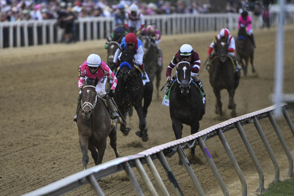 Flavien Prat atop Rombauer, left, wins the 146th Preakness Stakes horse race at Pimlico Race Course, Saturday, May 15, 2021, in Baltimore. (AP Photo/Will Newton)