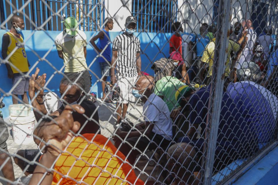 Inmates gather inside the National Penitentiary in downtown Port-au-Prince, Haiti, Sunday, March 3, 2024. Hundreds of inmates fled Haiti's main prison after armed gangs stormed the facility overnight. (AP Photo/Odelyn Joseph)