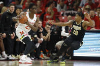Maryland forward Jalen Smith, left, looks for an open teammate against Purdue guard Nojel Eastern (20) during the first half of an NCAA college basketball game, Saturday, Jan. 18, 2020, in College Park, Md. (AP Photo/Julio Cortez)