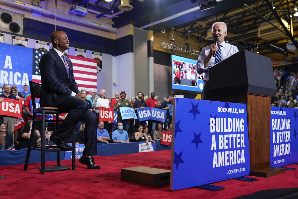 President Joe Biden speaks as Maryland Democratic gubernatorial candidate Wes Moore listens during a rally hosted by the Democratic National Committee at Richard Montgomery High School, Thursday, Aug. 25, 2022, in Rockville, Md. (AP Photo/Evan Vucci)