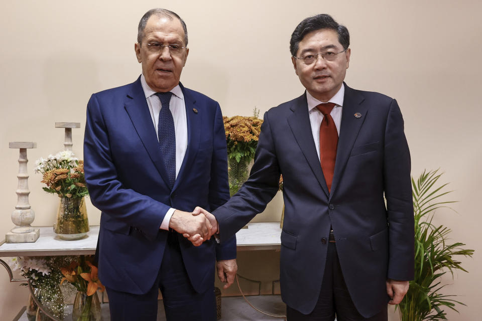 In this handout photo released by Russian Foreign Ministry Press Service, Russian Foreign Minister Sergey Lavrov, left, and Chinese Foreign Minister Qin Gang pose for photo on the sideline of G20 foreign minister's meeting in New Delhi, India, Thursday, March 2, 2023. (Russian Foreign Ministry Press Service via AP)