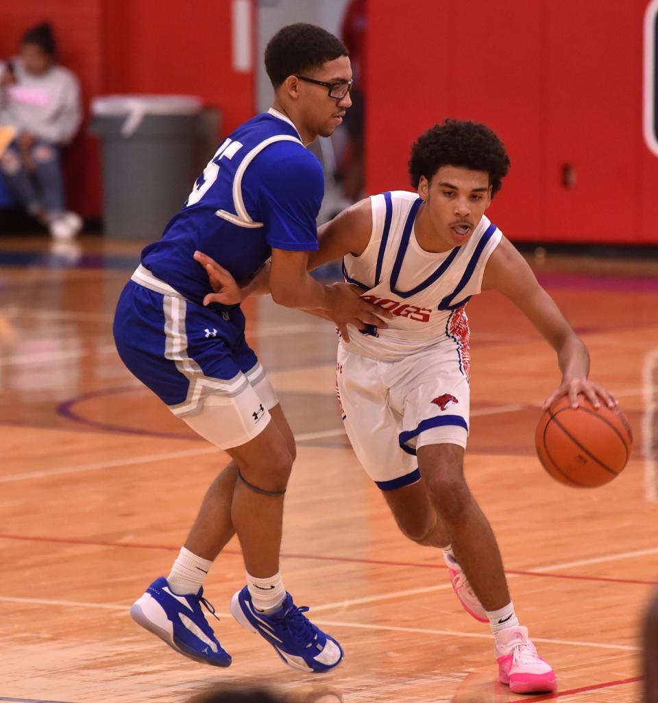 Cooper's Jordan Willis, right, tries to get around Lubbock Estacado's Tim Perez in the first half. Cooper beat the No. 11 4A Matadors 61-57 in double overtime in a non-district game Nov. 28 at Cougar Gym.