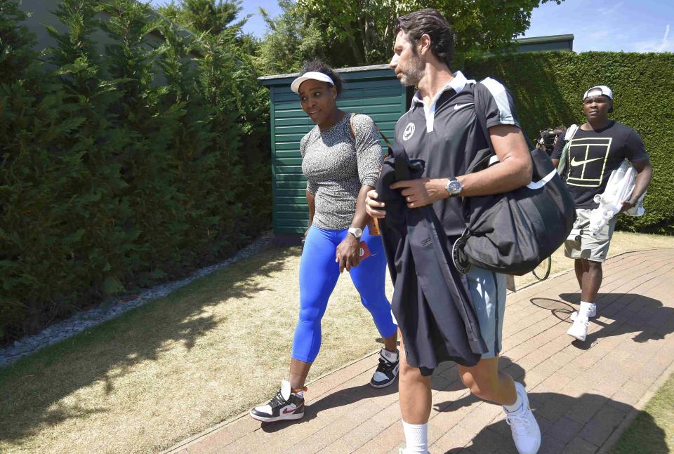 Serena Williams of the U.S.A. leaves the practice courts with coach Patrick Mouratoglou after a practice session at the Wimbledon Tennis Championships in London