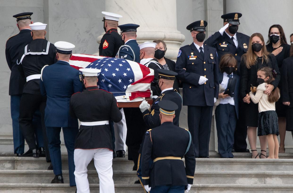 The family of US Capitol Police Officer William "Billy" Evans, including his children Logan and Abigail, watch as his casket arrives at the US Capitol where he will Lie in Honor in the Capitol Rotunda in Washington, DC, April 13, 2021, after he was killed in an attack on April 2.