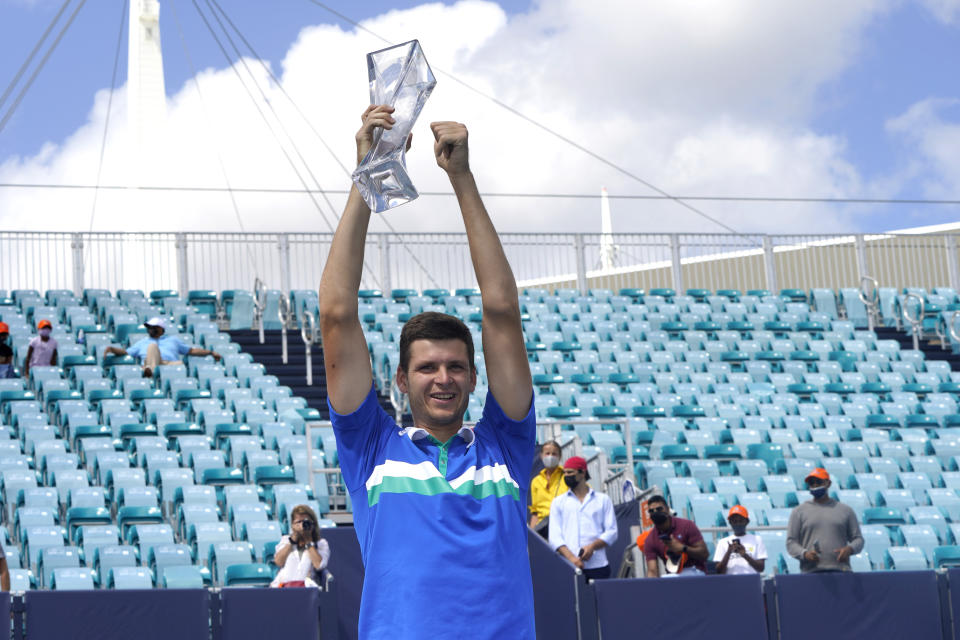 Hubert Hurkacz of Poland poses with the trophy after defeating Yannik Sinner of Italy during the finals of the Miami Open tennis tournament, Sunday, April 4, 2021, in Miami Gardens, Fla. Hurkacz won 7-6 (4), 6-4. (AP Photo/Lynne Sladky)