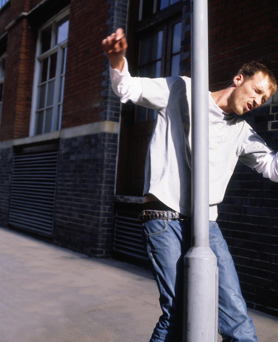 man walking into a pole