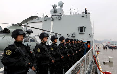 Soldiers of the Chinese People's Liberation Army stand on the deck before a fleet sets out for Aden, Yemen, from Zhoushan, Zhejiang province, April 3, 2015. REUTERS/Stringer