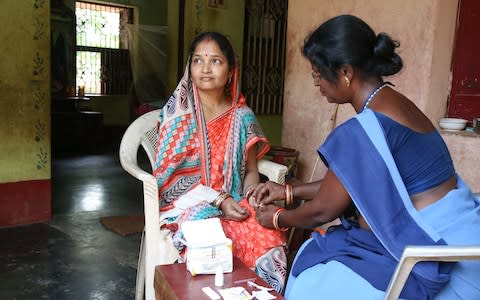 Swarnalata Jena is tested for malaria by the local ASHA, Meenakhi Maharana - Credit: Catherine Davison