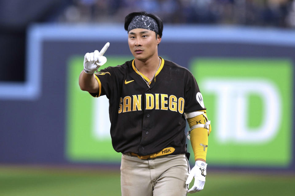 San Diego Padres' Ha-Seong Kim motions as the team challenges a play at first during the ninth inning of a baseball game against the Toronto Blue Jays on Wednesday, July 19, 2023, in Toronto. The replay confirmed that Kim had a single. (Chris Young/The Canadian Press via AP)