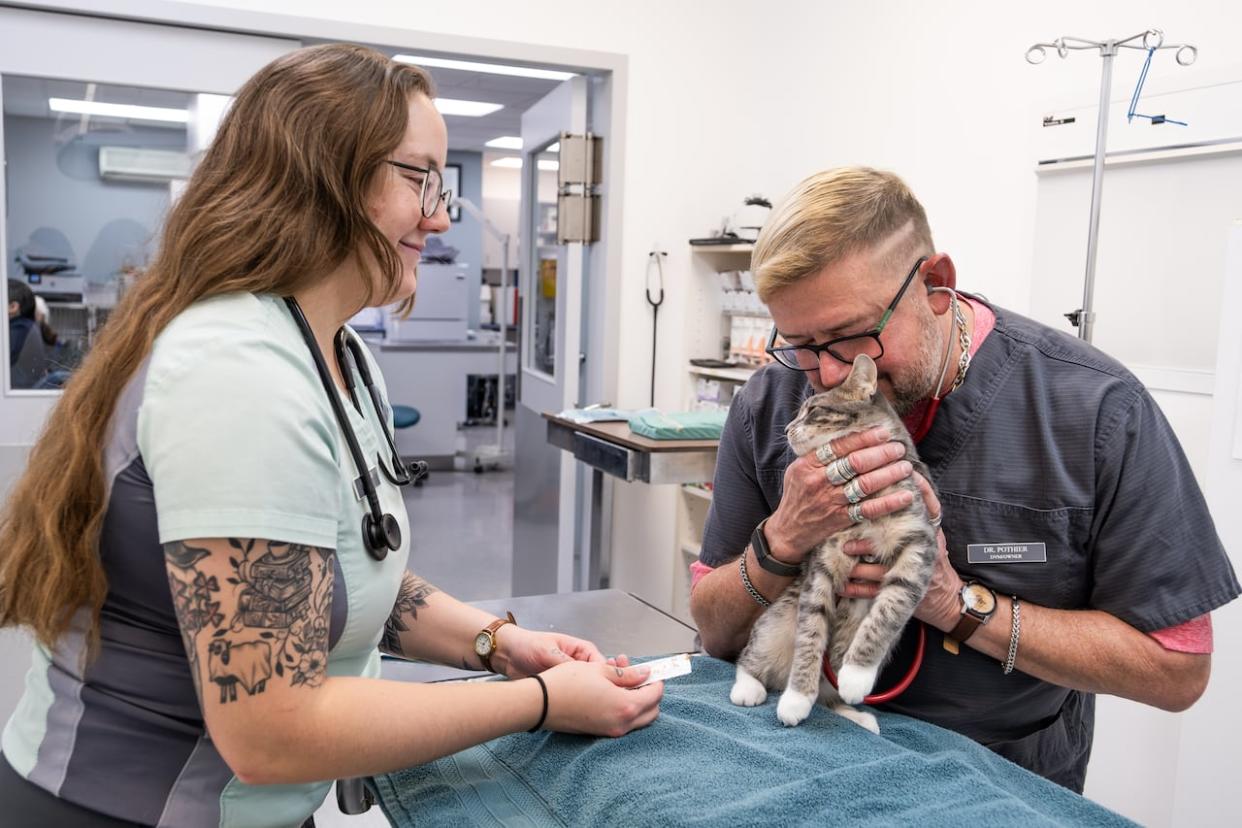 Veterinarians Neil Pothier, right, and Jordan-Star Bujold of the Bayview Animal Hospital are shown in Digby, N.S., on Nov. 2. Veterinarians in Canada say they are experiencing extreme burnout and plummeting mental health due to staff shortages, a booming number of animal patients and the round-the-clock stress of the job.  (Andrew Tolson/The Canadian Press - image credit)