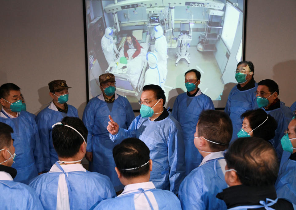 Chinese Premier Li Keqiang, wearing a mask and protective suit, speaks to medical workers on Jan. 27 as he visits the Jinyintan hospital where the patients of the new coronavirus are being treated following the outbreak, in Wuhan, China. (Photo: cnsphoto via Reuters)