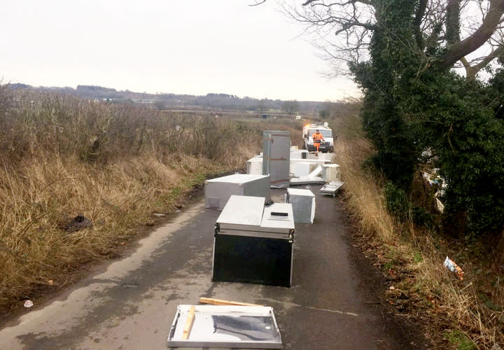 Open and shut case: The lorry - which did not have a registration plate - unloaded the industrial sized fridges into the middle of the road (SWNS) 