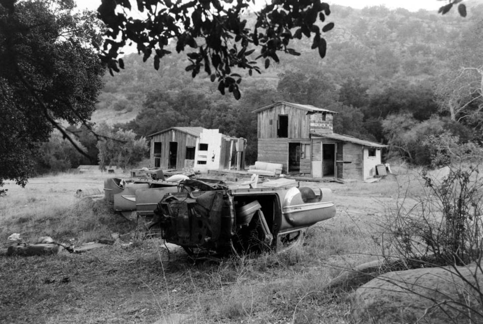 <div class="inline-image__caption"><p>"View of an upside-down car and a pair of dilapidated buildings on the Spahn Ranch property, Los Angeles County, California, August 29, 1969."</p></div> <div class="inline-image__credit">Ralph Crane/Getty</div>