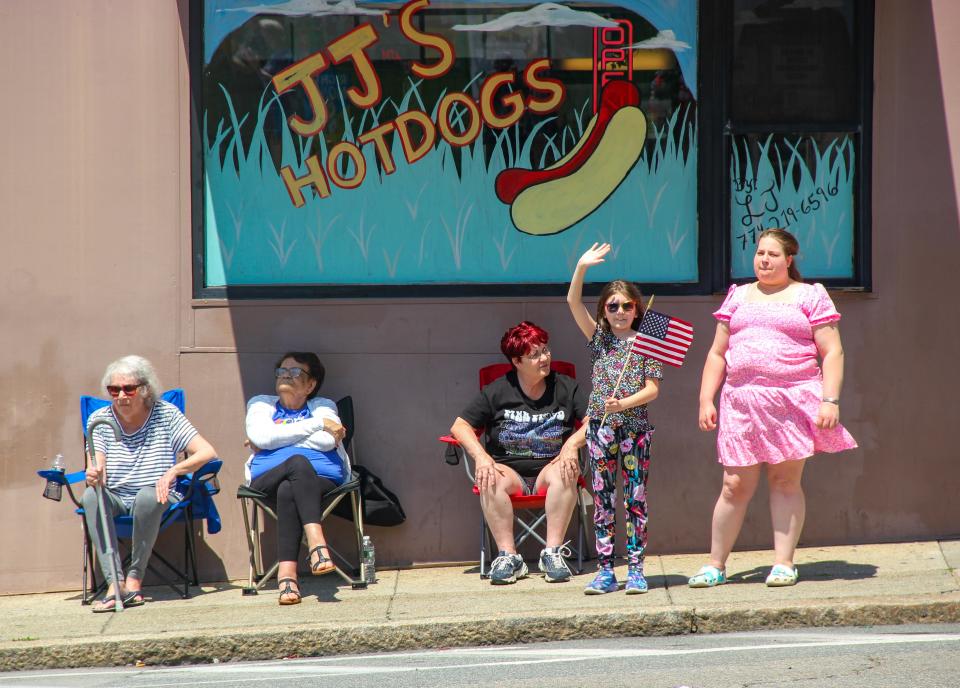 Spectators watch Fall River's Memorial Day parade outside JJ's Hot Dogs on South Main Street on Sunday, May 28, 2023.