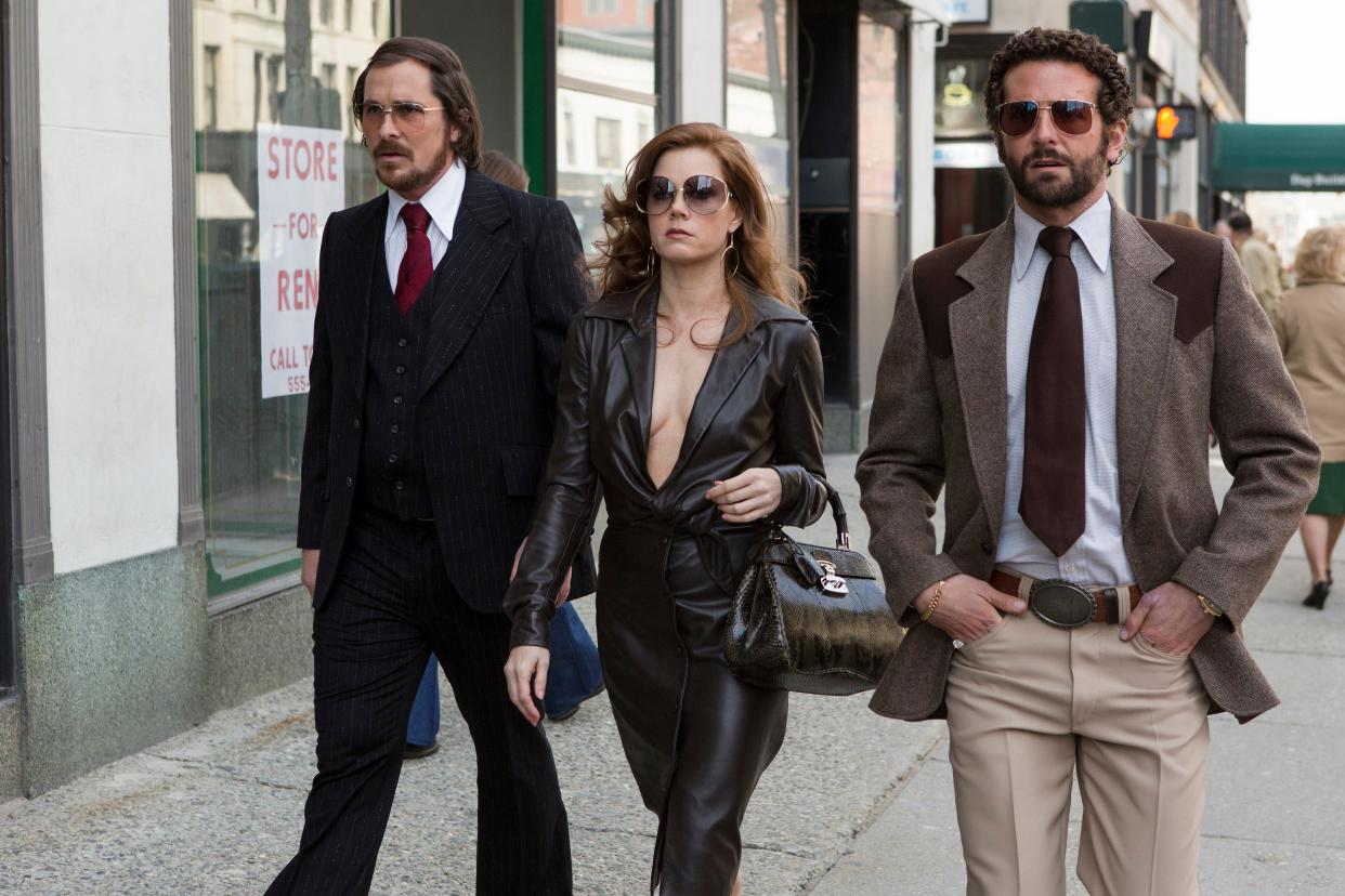 Christian Bale, Amy Adams and Bradley Cooper walk down Main Street in Worcester in a scene from "American Hustle." 