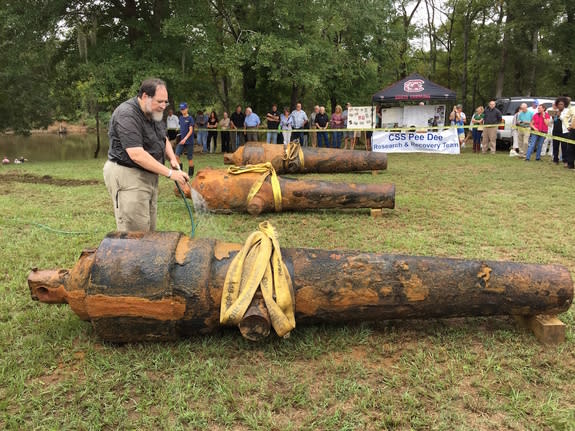 Despite having spent 150 years at the bottom of muddy river, all three cannons were in fairly good condition, according to Leader, who is seen here squirting the guns with water.