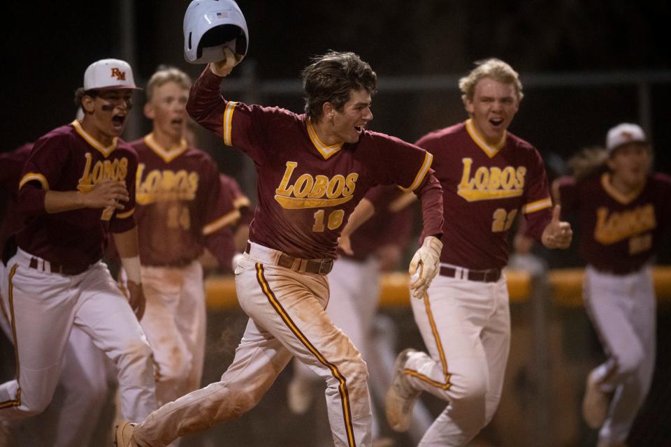 Rocky Mountain baseball players celebrate their walk-off win over Fort Collins High School at City Park in Fort Collins on Thursday, April 28, 2022.