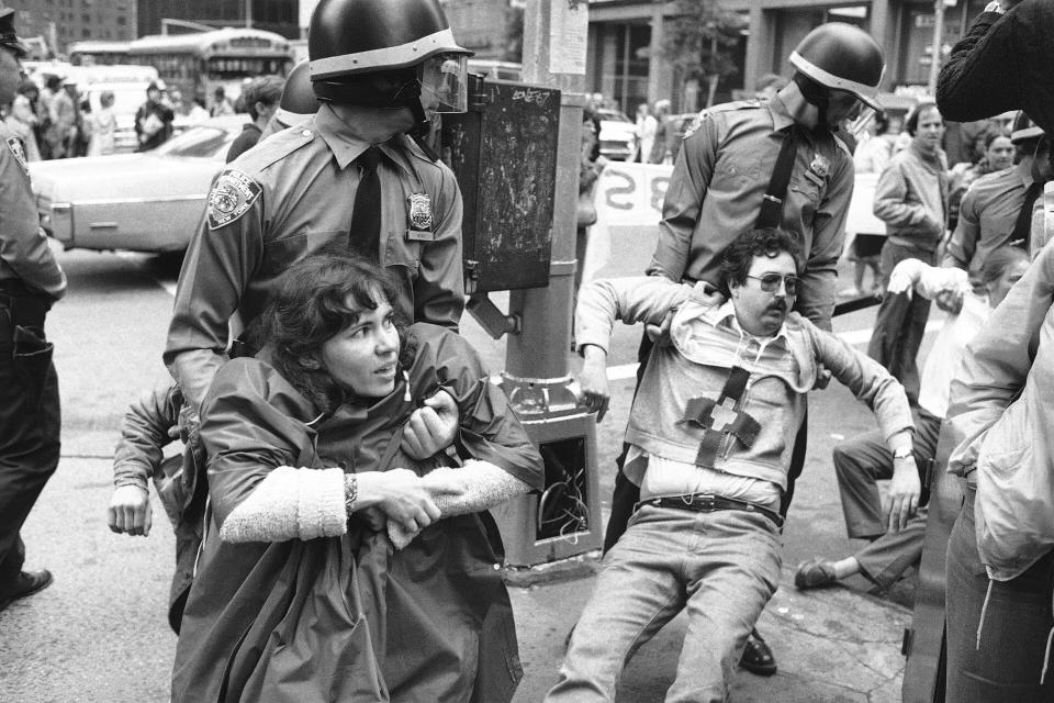 Anti-nuclear demonstrators are dragged away from a blockade of the British Mission to the United Nations by New York City police on June 14, 1982. (AP Photo/Mario Suriani)