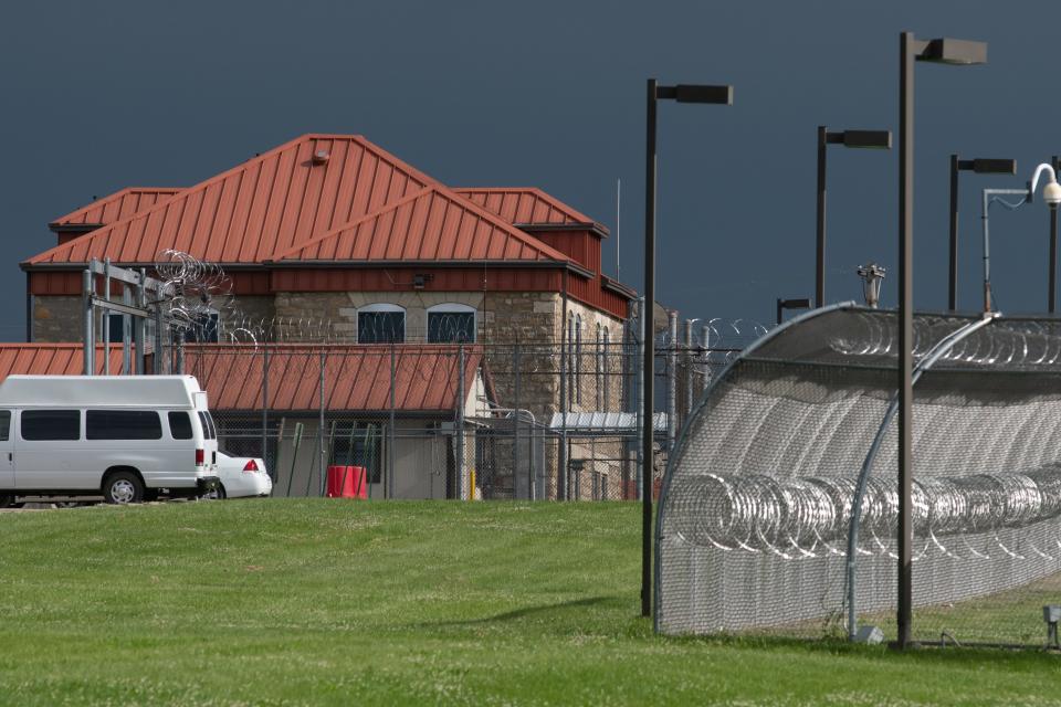 Some of the original Kansas Vocational School buildings dot the landscape at the Topeka Correctional Facility as lines of barbed wire fencing and security cameras block some of the view from S.E. 6th Street.