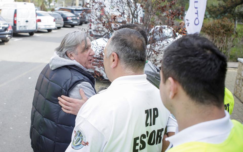 Ilie Nastase (L) is escorted off the arena's premises by stewards - REUTERS