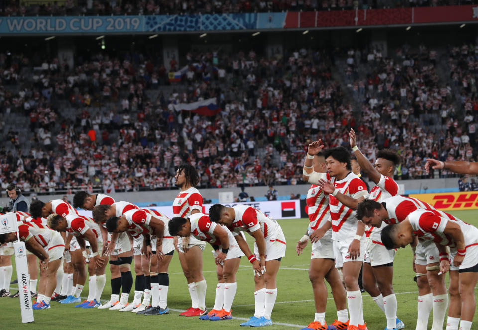 Japanese players acknowledge the crowd after the Rugby World Cup Pool A game at Tokyo Stadium between Russia and Japan in Tokyo, Japan, Friday, Sept. 20, 2019. Japan won the match 30-10. (AP Photo/Christophe Ena)