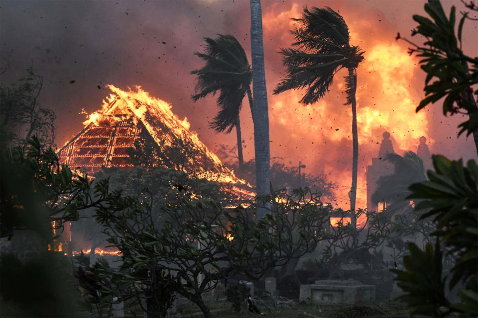 The hall of historic Waiola Church in Lahaina and nearby Lahaina Hongwanji Mission are engulfed in flames along Wainee Street on Aug. 8, 2023. (Matthew Thayer / The Maui News via AP)