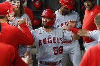 Los Angeles Angels' Jack Mayfield (59) is congratulated in the dugout by teammates after scoring on a wild pitch in the third inning of a baseball game against the Texas Rangers, Thursday, Aug. 5, 2021, in Arlington, Texas. (AP Photo/Brandon Wade)