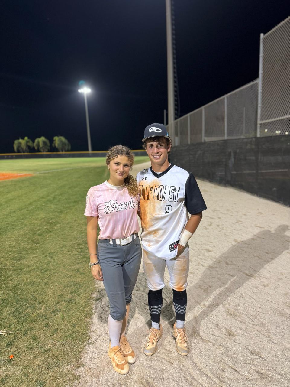 Gulf Coast's Melissa Hyatt (left) and Robert Hyatt (right) pose for a picture together following the baseball team's 4-3 win over Gulf Coast. Both Robert and Melissa delivered walk-off hits in their games Tuesday night.