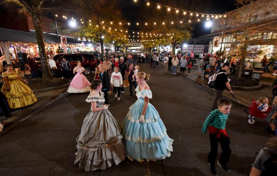 Dec 6, 2022; Tuscaloosa, Alabama, USA;  Northport hosted the annual Dickens Downtown on Main Ave. Tuesday, kicking off the Christmas season. Mollie Sims and Channing Vick, members of the Tuscaloosa Cameo Guild, wear Victorian dresses as they assist with the event. 