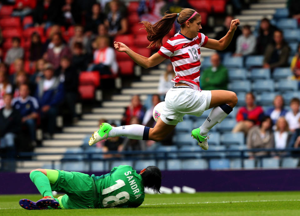 Alex Morgan of USA jumps over Sandra Sepulveda of Columbia during the Women's Football first round Group G match between United States and Colombia on Day 1 of the London 2012 Olympic Games at Hampden Park on July 28, 2012 in Glasgow, Scotland. (Photo by Stanley Chou/Getty Images)