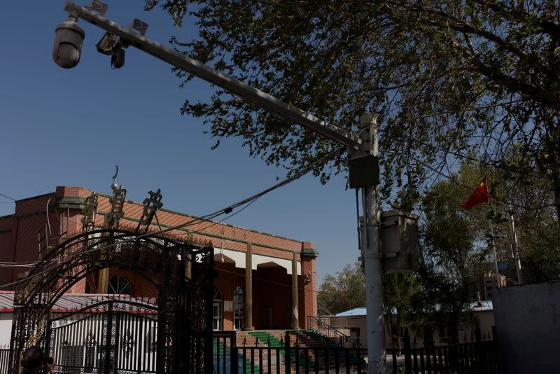 A Chinese national flag flies outside the former Xinqu Mosque that had its minarets and central dome removed in Changji outside Urumqi