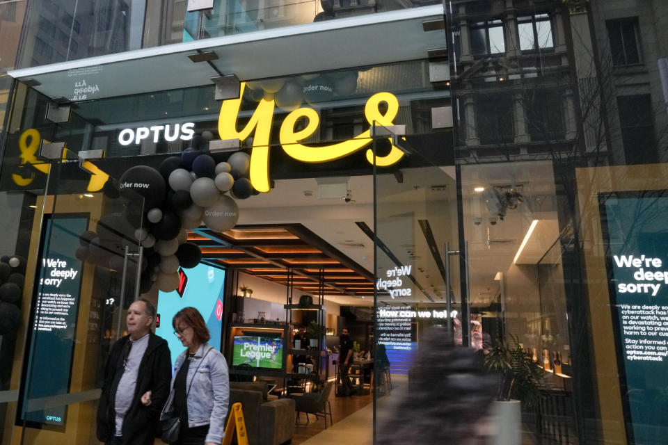 Customers walk out of an Optus telecommunications retail store in the central business district of Sydney, Australia, Wednesday, Oct. 5, 2022. The government has announced changes to telecommunications law, Thursday Oct. 6 to protect customers of Australia's second-largest wireless carrier, Optus, whose personal details were stolen in a major cyberattack. (AP Photo/Mark Baker)