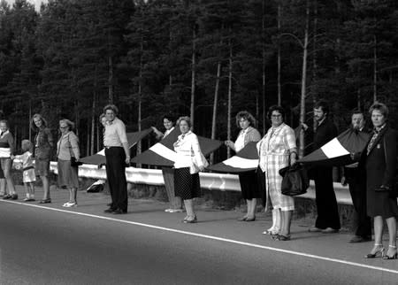 FILE PHOTO: People hold hands as they participate in a human chain during the Baltic Way near Riga