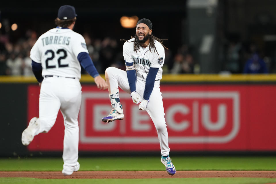 Seattle Mariners' J.P. Crawford, right, celebrates his game-winning, two-run double with Luis Torrens (22) against the Texas Rangers during the ninth inning of a baseball game Thursday, Sept. 28, 2023, in Seattle. (AP Photo/Lindsey Wasson)