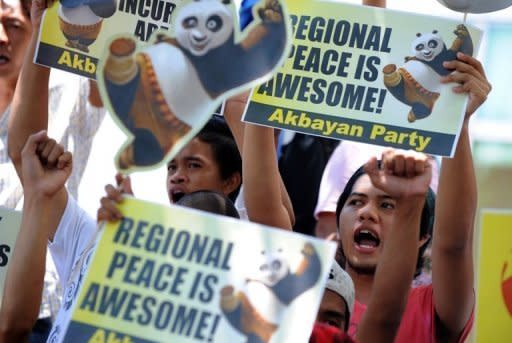 Philipine protesters shout slogans outside the Chinese Consular Office in Manila. The Philippines has said it will send its ageing navy flagship into disputed South China Sea waters amid rising tensions with Beijing over their competing claims