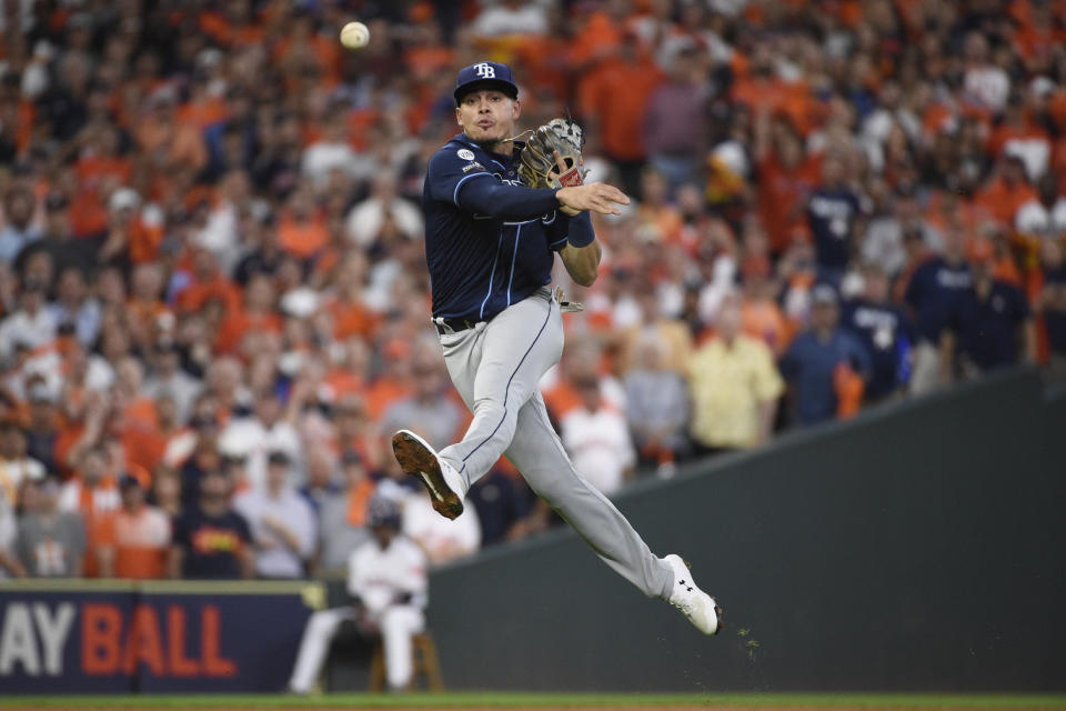 Tampa Bay Rays shortstop Willy Adames (1) throws to first to make the out on Houston Astros designated hitter Yordan Alvarez during the first inning of Game 5 of a baseball American League Division Series in Houston, Thursday, Oct. 10, 2019. (AP Photo/Eric Christian Smith)